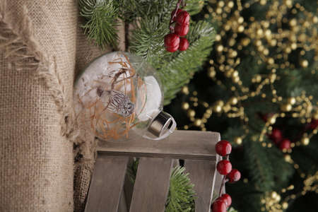 christmas toys on the background of a green Christmas tree with flashlightsの写真素材