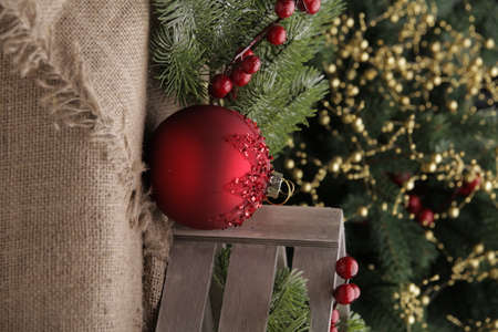 christmas toys on the background of a green Christmas tree with flashlightsの写真素材