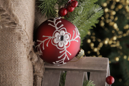 christmas toys on the background of a green Christmas tree with flashlightsの写真素材