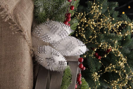 christmas toys on the background of a green Christmas tree with flashlightsの写真素材