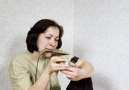woman holds a syringe