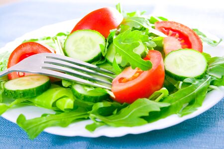 Fresh salad with tomatoes, rucola and cucumbersの写真素材