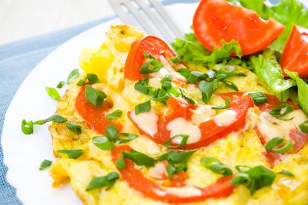 Omelet with tomatoes and green onions