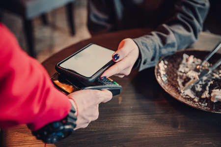 Contactless mobile payment. Mobile payment in cafe with smart phone nfc near field communication...