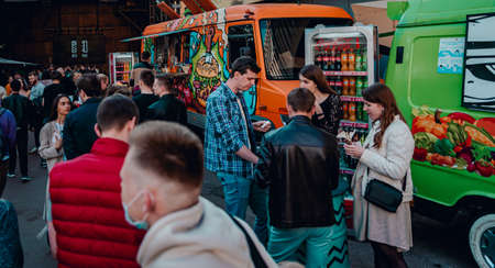 Minsk, Belarus - May 16, 2021: crowd of people buy meals from food truck. street food.