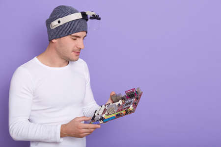 Faceless technician repairing smartphone's motherboard. Concept of computer hardware, mobile phone,...