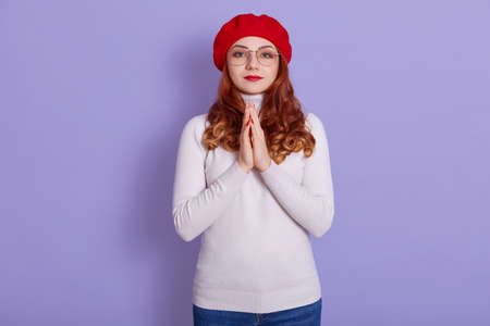 Close-up portrait of nice attractive pretty girl keeping arms together asking favor, expecting luck...