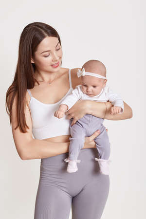 Loving young European mother hold little newborn infant child, enjoying moment together, caring mom...