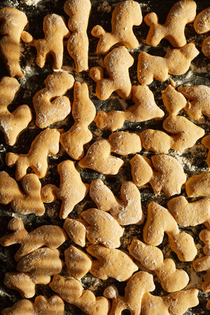 Top view of baking pan with baked different shape cookies, homemade pastry, delicious bakary...