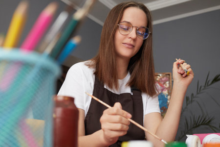 Painter with a colorful palette. Workshop for artistic expression. Craftsmanship in painting...