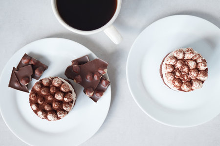 Cup of coffee and chocolate cakes tiramisu on white background, top viewの写真素材