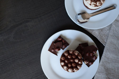 Coffee chocolate and tiramisu on a plate on a wooden table.