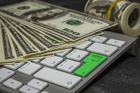 A lot of money on a computer keyboard