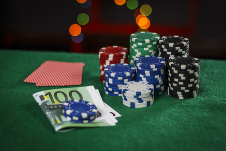 Poker chips, euros and cards on the green tableの写真素材