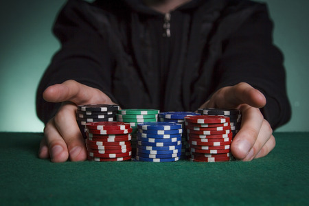 The guy in the black sweatshirt puts all the chips in poker