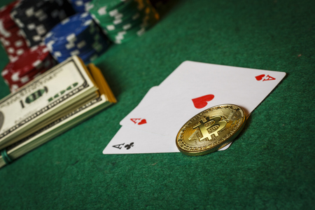 Bitcoin gold coin on the poker table with chipsの写真素材