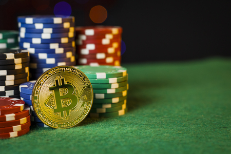 Bitcoin gold coin on the poker table with chipsの写真素材