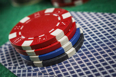 Poker chips on the game cards on the poker table close up