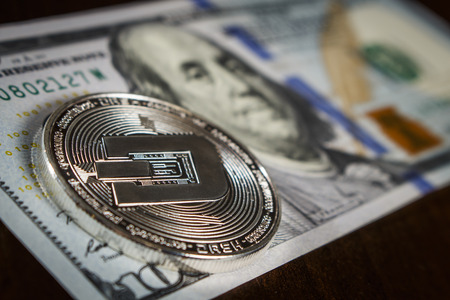 Dash coin on the hundred dollar billの写真素材
