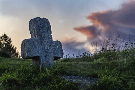 Pskov region, the village of Mali; stone cross against the evening skyの写真素材