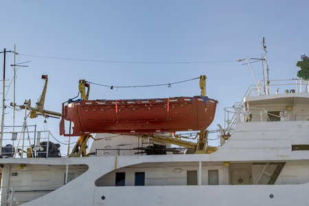 Orange rescue boat on the cargo vesselの写真素材