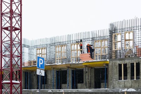 workers in orange workwear on construction site
