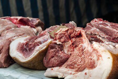 large pieces of pork meat on an open counter. street tradingの写真素材