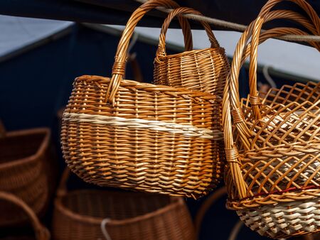 several wicker baskets at an outdoor counter in a street marketの写真素材