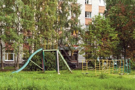 summer landscape with an old metal children s slide in a poor Russian townの写真素材