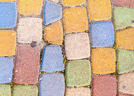 background of multi-colored bricks with which the path is pavedの写真素材