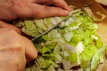 chinese cabbage, bok choy is chopped with a knife