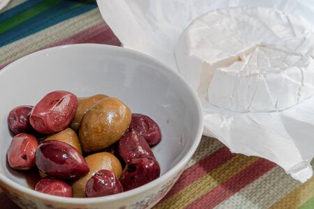 still life with white-moulded cheese and kalamato olivesの写真素材