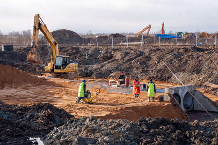 Saint Petersburg, Russia - 11 February 2020. excavator flattens the site out of sand. construction workのeditorial素材