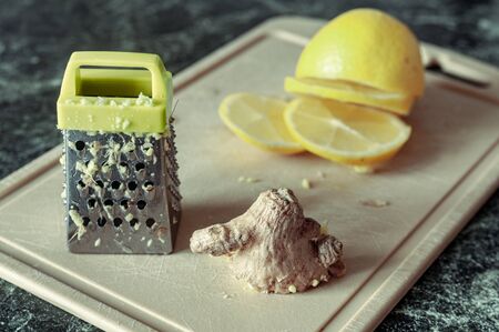 still life with ginger root, lemon and miniature graterの写真素材