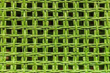 Pattern of green wicker threads. Abstract background with empty space for textの写真素材