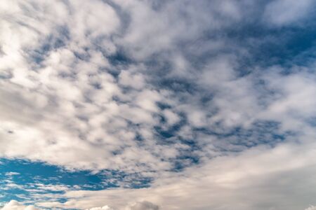 abstract background with cloudy sky. White sparse clouds over blue sky