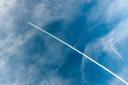 abstract background with blue sky and a trace from the planeの写真素材