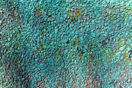 abstract background with a wall painted with turquoise paint. Moss grows on the wallの写真素材