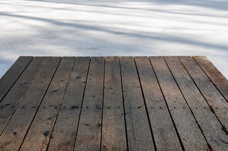 background with a boat pier from the boards at the frozen lakeの写真素材
