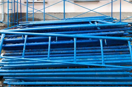 blue metal scaffolding stacked before installation. reconstruction the facadeの写真素材