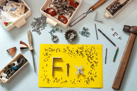Top view of construction tools and a construction fastener. Piece of paper with the word Fix laid...