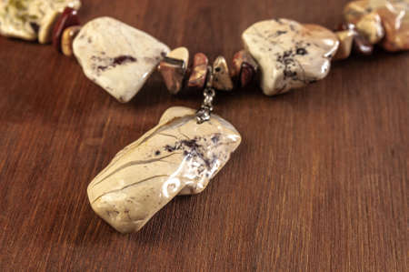 necklace made of Ural Jasper on wooden backgroundの写真素材
