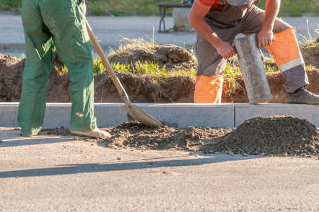 road works. the installation of new concrete curbsの写真素材