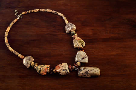 necklace made of Ural Jasper on wooden backgroundの写真素材