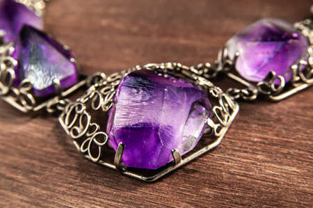 close up of necklace with amethyst on wooden backgroundの写真素材