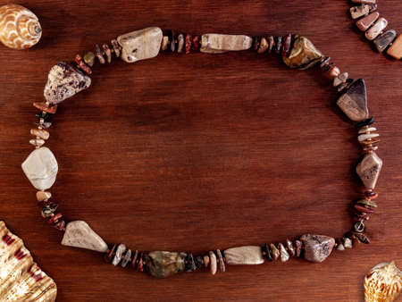 flat Lay with seashells and natural stone bracelet on a wooden backgroundの写真素材