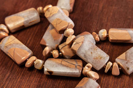 beads made of ural Jasper on wooden backgroundの写真素材