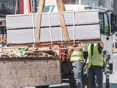 unloading concrete curbs. road works. the installation of new curbs