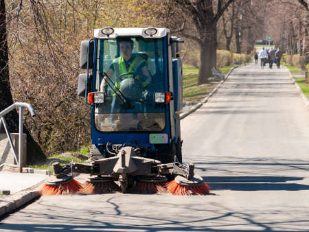 Petrozavodsk, Russia - 10 May 2020. sweeper in the process of cleaning the sidewalk. street cleaning equipmentのeditorial素材