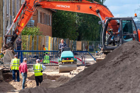 Petrozavodsk, Russia - 2 September 2019. An excavator, road roller and several workers perform road...